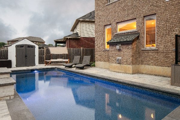 Pool Design and Construction Photo of Relaxing Pool Patio and Shed