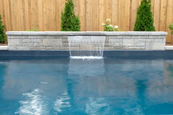 Ancaster new subdivision backyard transformation with in-ground pool and interlocking patio by Boulder Design Pools & Landscapes