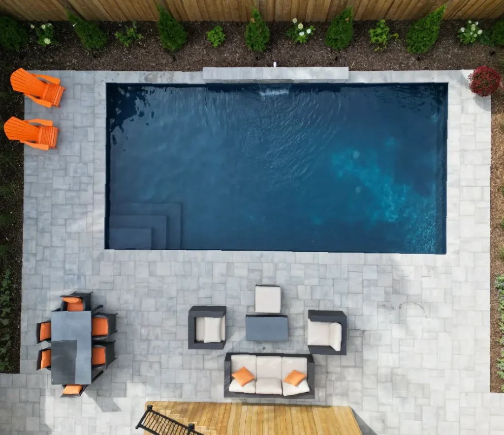 Ancaster new subdivision backyard transformation with in-ground pool and interlocking patio by Boulder Design Pools & Landscapes
