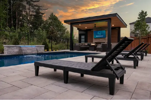 A backyard pool, patio and deck build in Mount Hope, Ontario by Boulder Design Pools and Landscapes