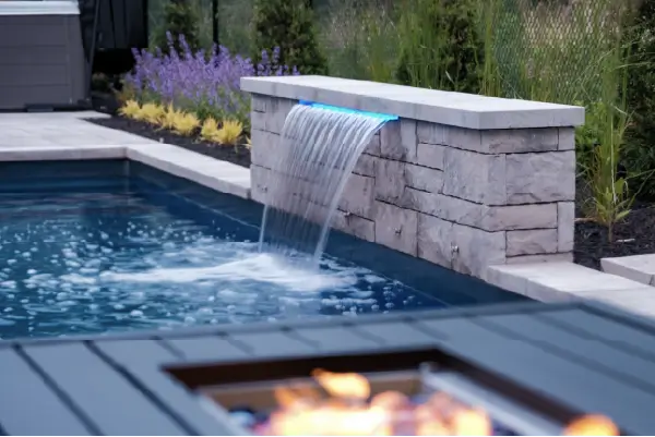 A backyard pool, patio and deck build in Mount Hope, Ontario by Boulder Design Pools and Landscapes