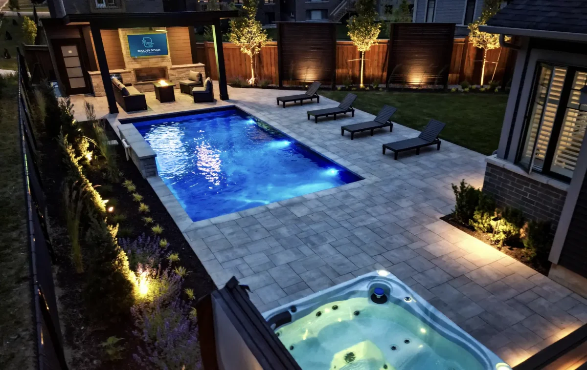 A backyard pool, patio and deck build in Mount Hope, Ontario by Boulder Design Pools and Landscapes