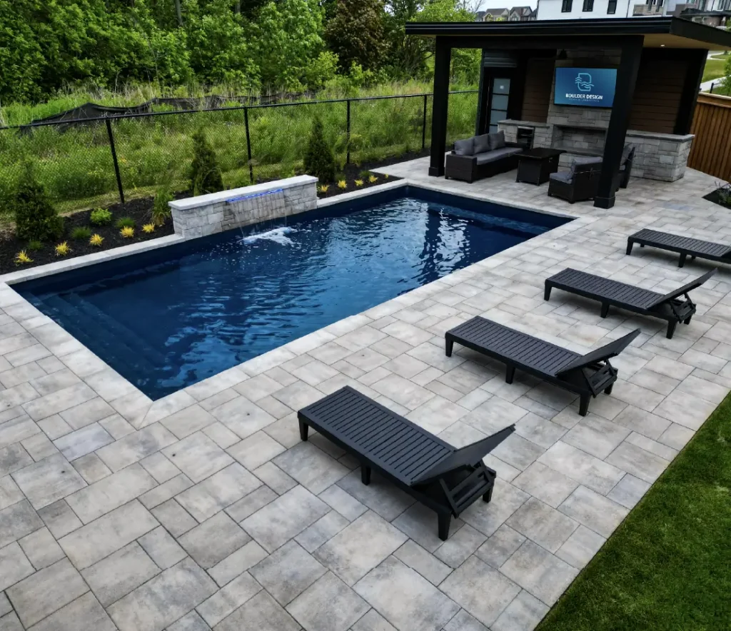 A backyard pool, patio and deck build in Mount Hope, Ontario by Boulder Design Pools and Landscapes