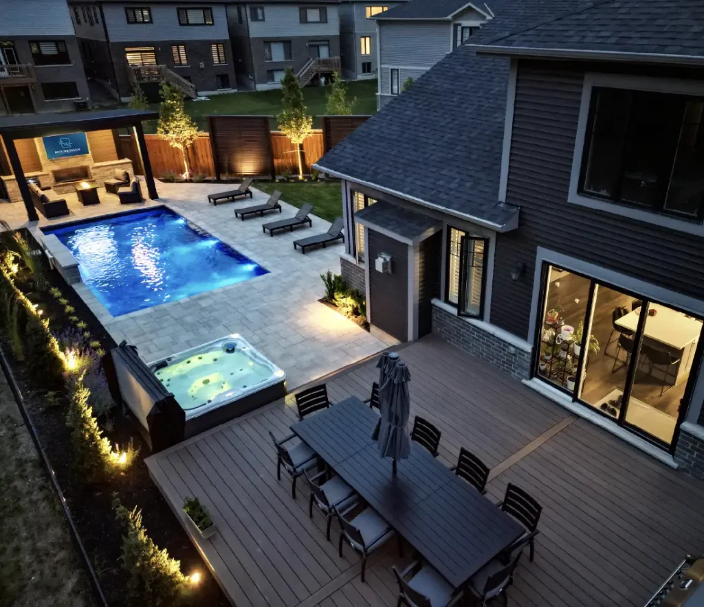 A backyard pool, patio and deck build in Mount Hope, Ontario by Boulder Design Pools and Landscapes