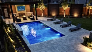 A backyard pool, patio and deck build in Mount Hope, Ontario by Boulder Design Pools and Landscapes