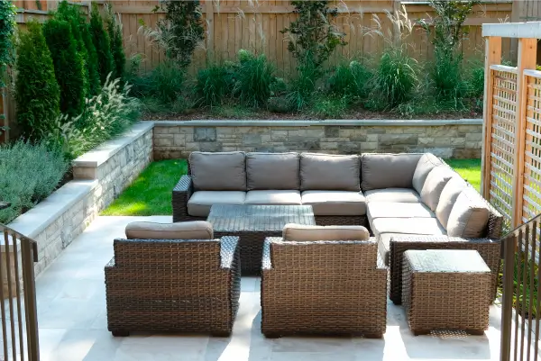A backyard in Hamilton, Ontario with new patio and retaining wall by Boulder Design Pools and Landscapes