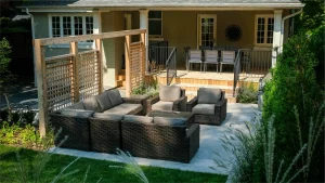 A backyard in Hamilton, Ontario with new patio and retaining wall by Boulder Design Pools and Landscapes