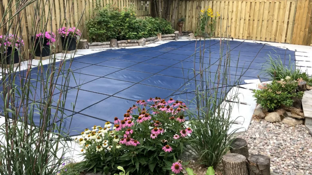 Boulder Design installing Latham safety pool covers on pool builds